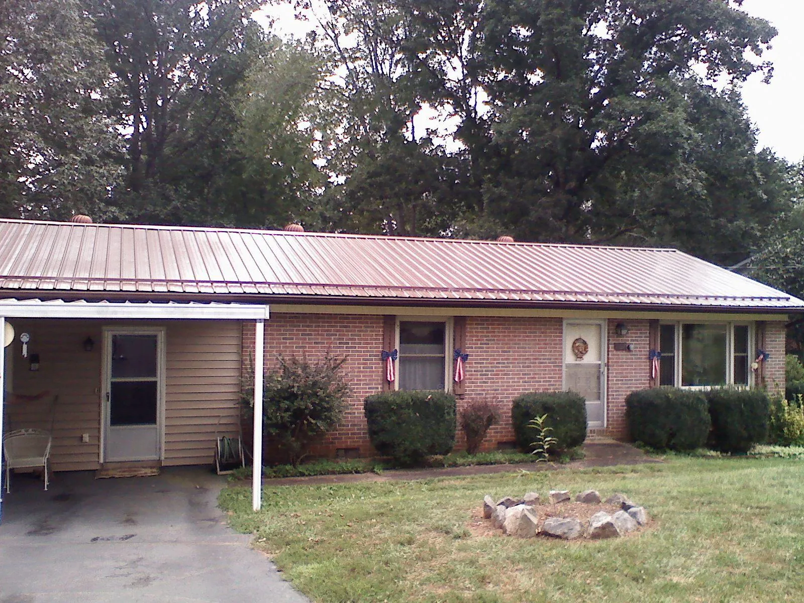 Bronze metal roof and carport on a brick ranch home — Roof Repair work by our crew in Mayer