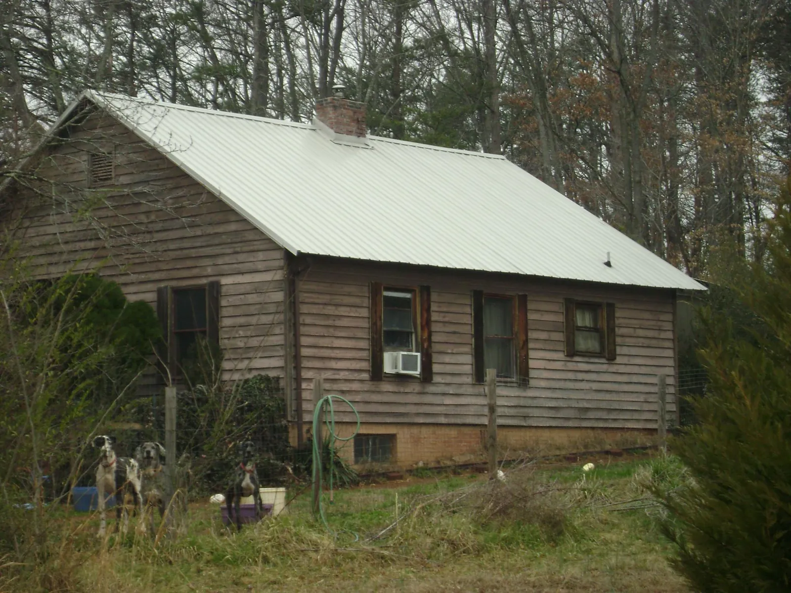 White metal roof on an old wood sided farmhouse, from a Metal Roof Installation job in Mayer